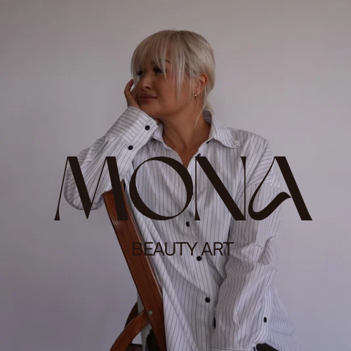 Woman with short blonde hair sits on a chair, wearing a striped shirt. Text reads "MONA BEAUTY.ART.